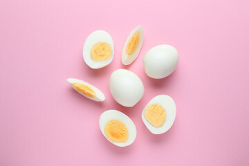 Fototapeta na wymiar Fresh hard boiled eggs on pink background, flat lay