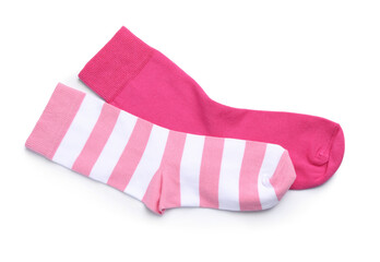 Different pink socks on white background, top view