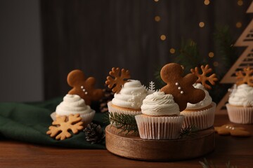 Different beautiful Christmas cupcakes and fir branches on wooden table. Space for text - Powered by Adobe
