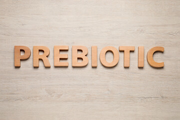 Word Prebiotic made of letters on wooden table, top view