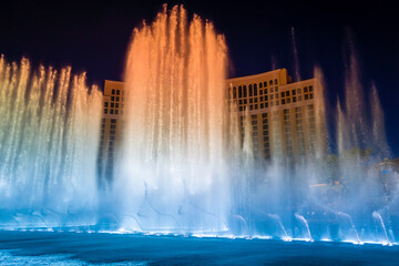 Las Vegas City Nightscape with red and blue night water fountain display in Nevada, USA