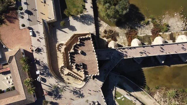 Cordoba, Spain: Aerial to down drone footage of the Calahorra  tower and the Roman bridge above the  Guadalquivir river in Cordoba in  Andalusia in southern Spain.