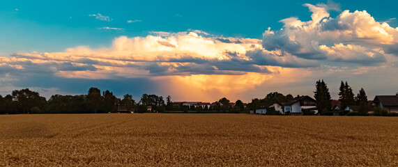 Beautiful sunset with a distant thunderstorm near Tabertshausen, Bavaria, Germany