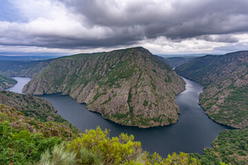 Dark clouds over a river canyon