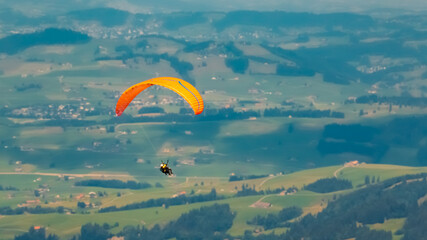 Beautiful alpine summer view with a paraglider at the famous Hoher Kasten summit, Bruelisau,...