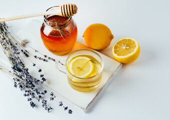 tea with lemon honey jar lemon on white background