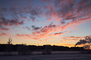 Fototapeta premium The silhouette of the night city, Darkening in the bright red sky..