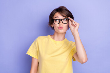 Portrait of minded creative person arm touch eyeglasses look empty space isolated on purple color...