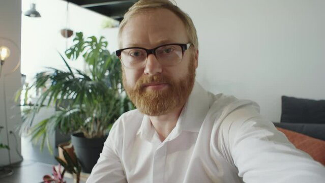 POV Of Bearded Caucasian Businessman In Formal Shirt And Glasses Looking At Camera And Speaking On Online Video Call