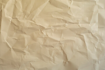 Obraz premium Crumpled paper in warm color as a background.