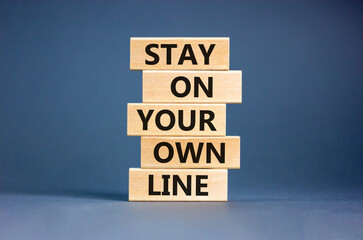 Stay in your own line symbol. Concept words Stay in your own line on wooden blocks. Beautiful grey table grey background. Business and stay in your own line concept. Copy space.