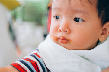 Asian baby refuse to eat food, refusing to eat food from spoon with mouth dirty