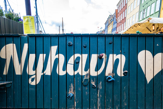 Copenhagen, Denmark, A blue sign says Nyhavn, or new harbor, a famous landmark.