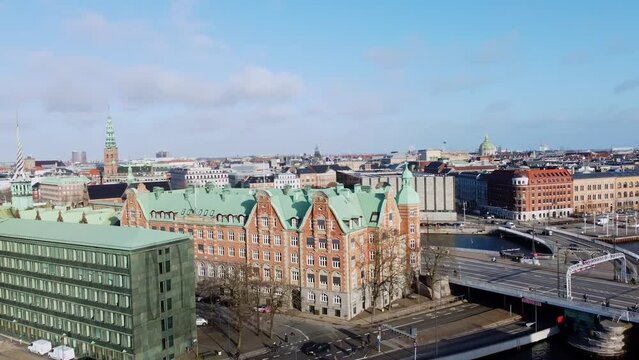 Copenhagen, Denmark: Aerial footage of Copenhagen historic center with landmarks such as the National Bank, the Christiansborg palace and the Borsen ancient building in Denmark capital city in winter