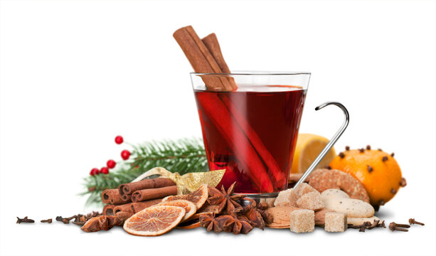 Glass with Hot red mulled wine for winter and Christmas with orange slice, anise and cinnamon sticks isolated on white background