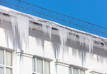 Icicles hang from the roof of the house.