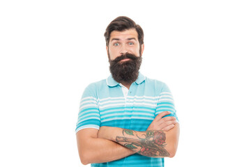 Bearded man in doubt. Doubtful man raising brows. Unshaven man keeping arms crossed