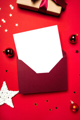 Envelope with letter and gift on a red background