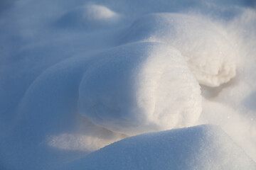 White fluffy snow on the ground as a background.