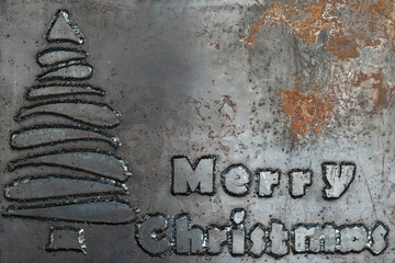 Hard phrase merry christmas made from steel letters welded to a steel sheet. Unusual Christmas...