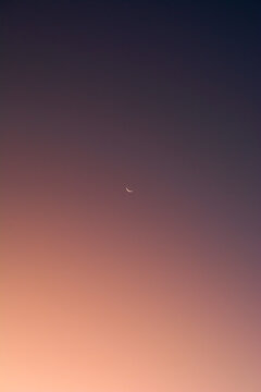 half moon in the sky at sunset
