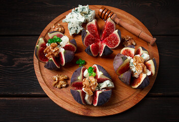 Appetizer, Figs with blue cheese, walnut, honey, on a wooden board, top view, close-up, no people,