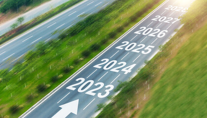 Top view of empty asphalt road with numbers 2023, 2024 to 2028