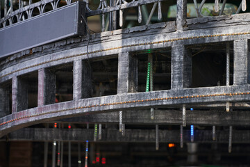 A fragment of a graphite building with imitation window openings and a roof terrace. Selective focus.