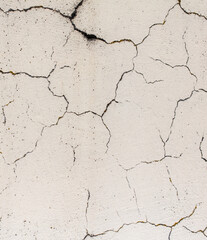 Cracked plaster on the wall of the house.