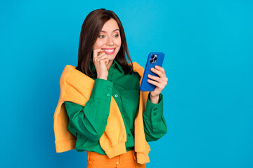 Photo of charming positive person finger touch lips use telephone facebook telegram whatsup instagram isolated on blue color background