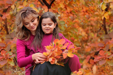 Mother and daughter collecting autumn bouquet