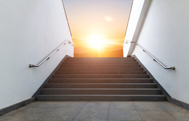 Empty staircase leading to sunrise sky