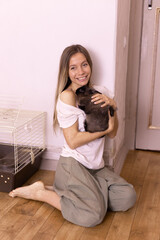 Woman holding cute fluffy rabbit, animal and pet concept