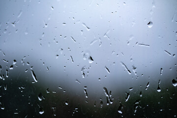 Raindrops on dirty window glass, background.