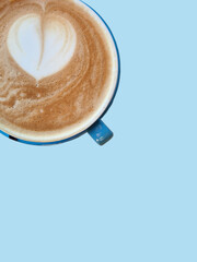 blue cup of coffee on light blue background, latte art, heart shape, milk foam vertical. Background for invitation card, calendar, postcard, gift paper, wallpaper copy space retro pattern. Banner