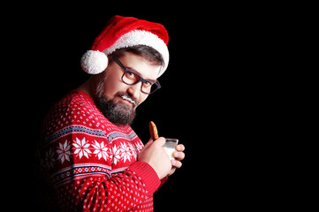 Man drinking milk and eating Christmas cookie