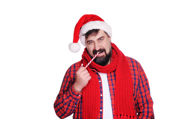 Man with beard wearing santa hat smiking lollipop