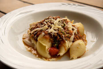 Italian pasta conchiglione with bolognese sauce