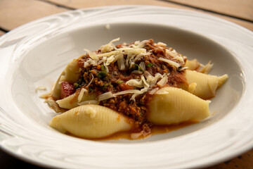 Italian pasta conchiglione with bolognese sauce