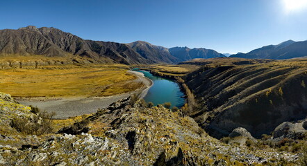 Fototapeta na wymiar Russia. South of Western Siberia, the Altai Mountains. Picturesque high-altitude view in autumn colors of the Katun River near the village of Inegen.