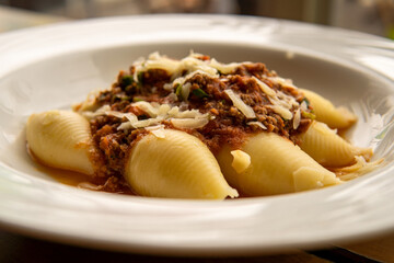 Italian pasta conchiglione with bolognese sauce