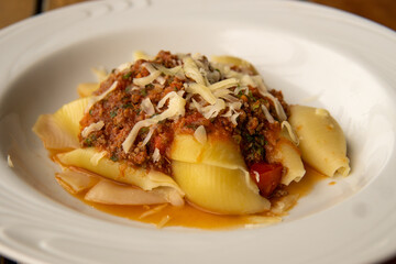 Italian pasta conchiglione with bolognese sauce