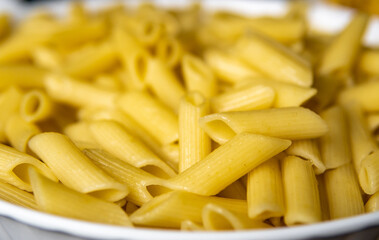 close penne pasta in a bowl
