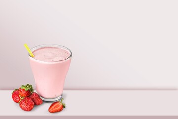 Tasty sweet milk smoothie with strawberry on the table
