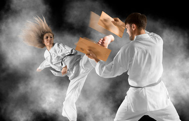 Taekwondo master breaks a wooden board with his foot