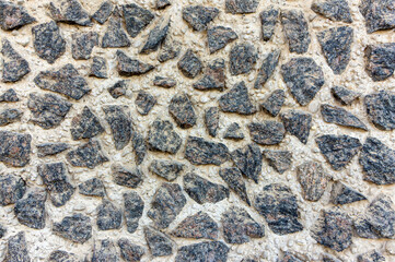 A mosaic of various pebbles on the wall