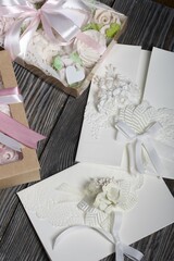 Homemade marshmallows in a gift box. Tied with ribbon. Zephyr flowers. Homemade greeting card in white. With decorative elements. Ribbons, flowers and leaves are attached to cardboard.