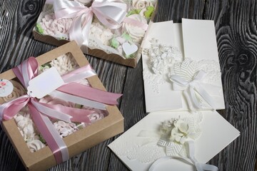 Homemade marshmallows in a gift box. Tied with ribbon. Zephyr flowers. Homemade greeting card in white. With decorative elements. Ribbons, flowers and leaves are attached to cardboard.