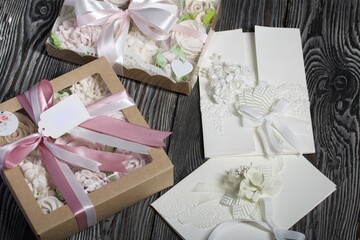 Homemade marshmallows in a gift box. Tied with ribbon. Zephyr flowers. Homemade greeting card in white. With decorative elements. Ribbons, flowers and leaves are attached to cardboard.