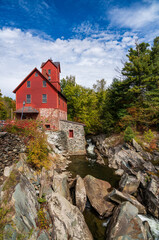 Side view of the Old Red Mill by the creek in Jericho Vermont during the fall